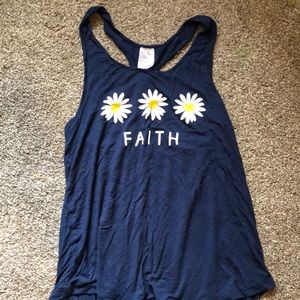 blue tank top with white flowers and the word “faith”